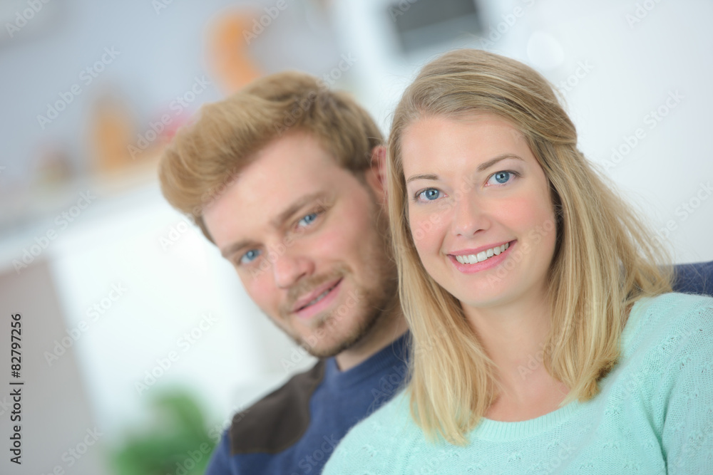Affectionate couple sat on a sofa Affectionate couple sat on a sofa