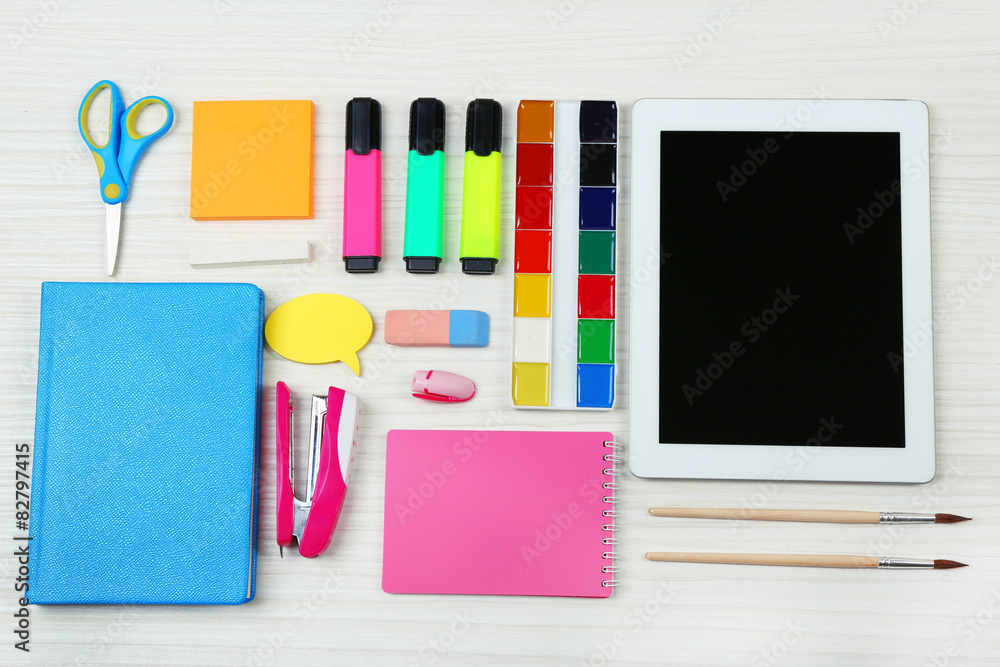Digital tablet with stationery on wooden background Digital tablet with stationery on wooden background