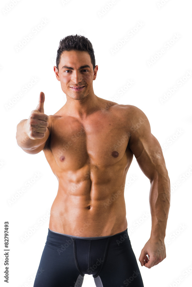 Fototapeta premium Muscular man shirtless doing thumb up sign for OK, smiling