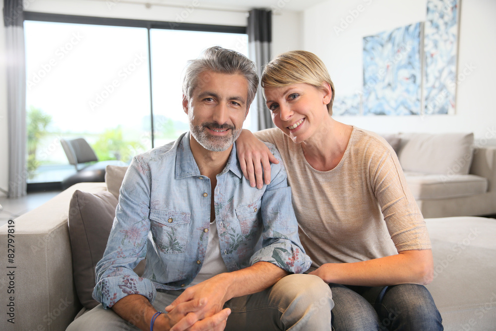 Middle-aged couple relaxing in sofa at home Middle-aged couple relaxing in sofa at home