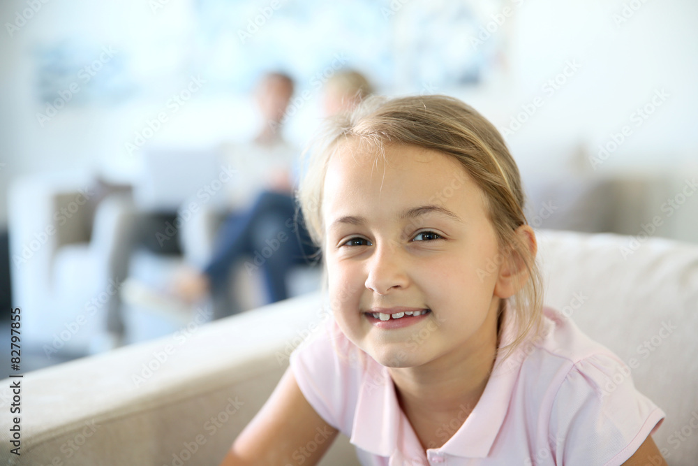 Portrait of 8-year-old girl sitting in sofa Portrait of 8-year-old girl sitting in sofa