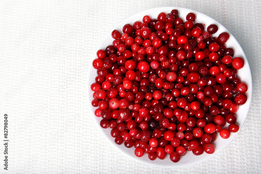 Cranberries in bowl on table close up Cranberries in bowl on table close up