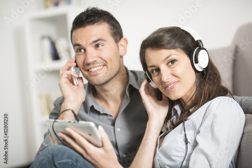 young couple using tablet pc at home photo