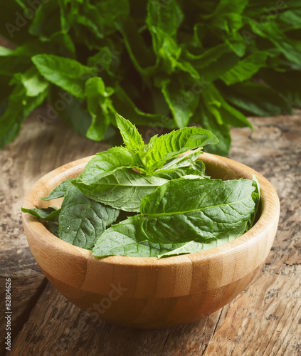 Fresh mint on an old wooden table, selective focus