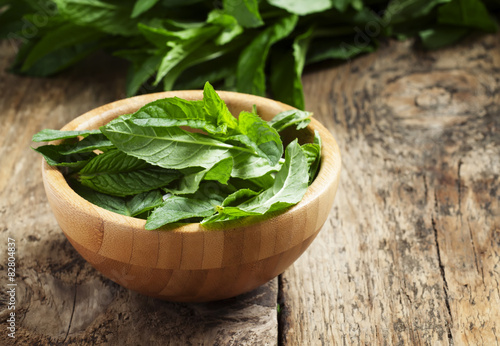 Fresh mint on an old wooden table, selective focus