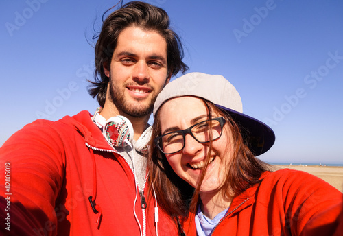 couple having fun taking selfie with smrtphone. photo