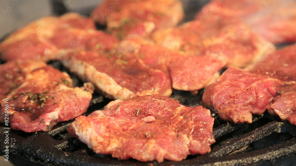 Pork, chicken and beef steaks on barbecue grill in warm tones Pork, chicken and beef steaks on barbecue grill in warm tones