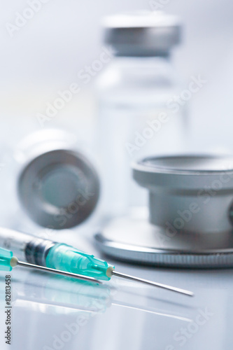 Medical equipment : stethoscope ampoules and syringe on white ba