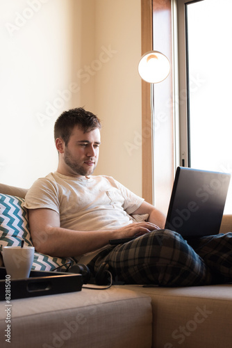 Man with laptop at living room photo