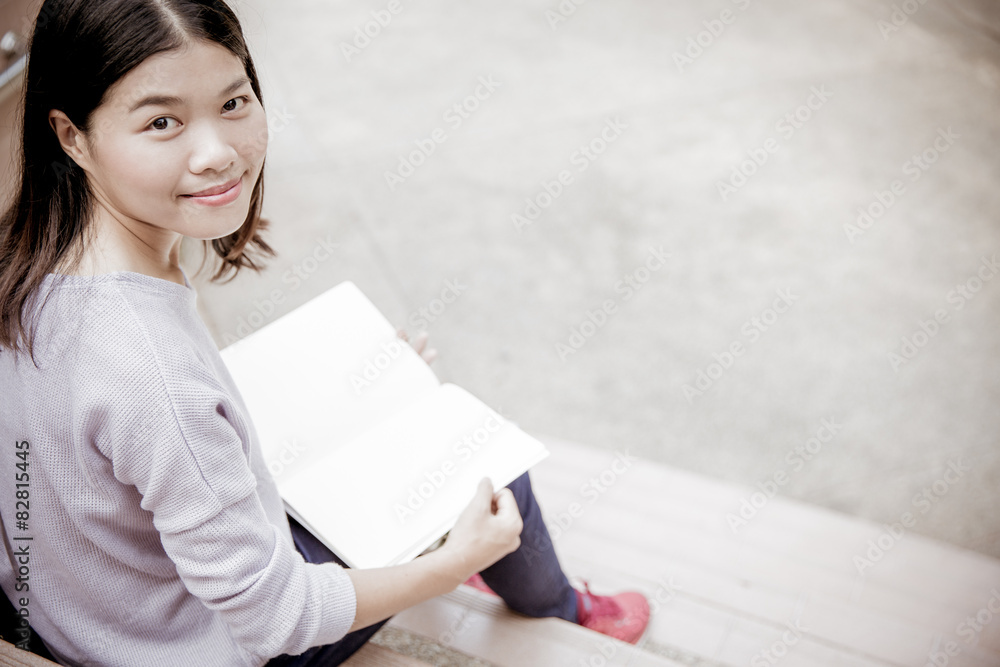 attractive female college student sitting on stairs attractive female college student sitting on stairs