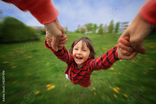 Принти на полотні Mother, spinning in circle her little baby boy, pure joy, radial