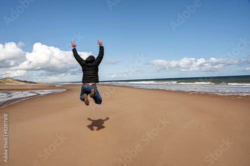 Man jumping for joy on the beach