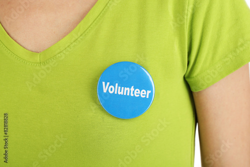 Round volunteer button on shirt of girl photo