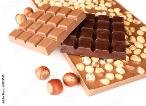 Black and milk chocolate bars with hazelnuts isolated on white
