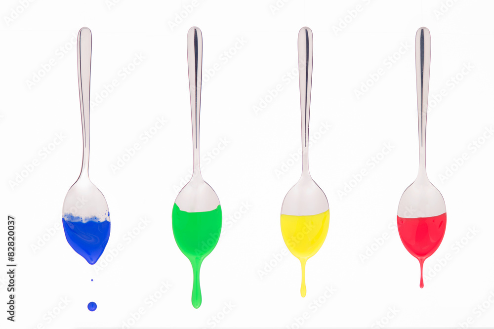 spoons suspended bathed in colored paint spoons suspended bathed in colored paint