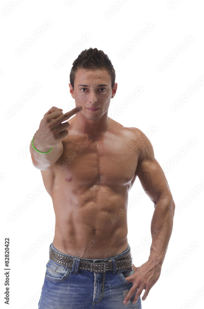 Shirtless muscular young man holding up middle finger Stock Photo