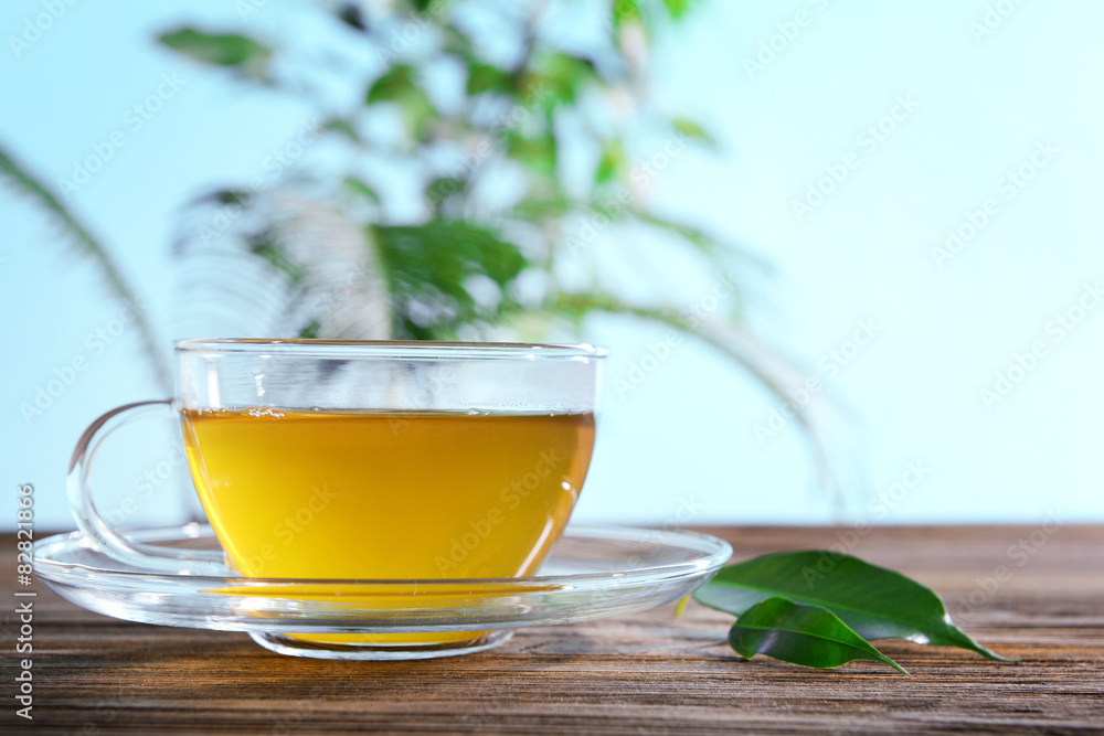 Cup of green tea on table on green background Cup of green tea on table on green background