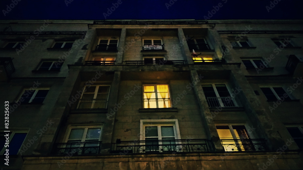 Building or house with lighting windows at evening or night