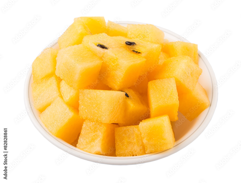 Bite size yellow watermelon in a white bowl Bite size yellow watermelon in a white bowl
