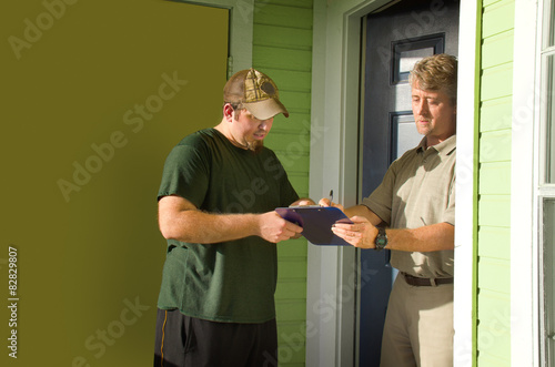 Obraz na plátně Man signing door-to-door questionnaire survey or petition