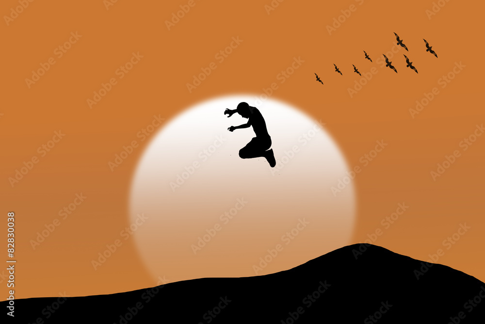 Silhouettes of children jumping on mountain sunset background.
