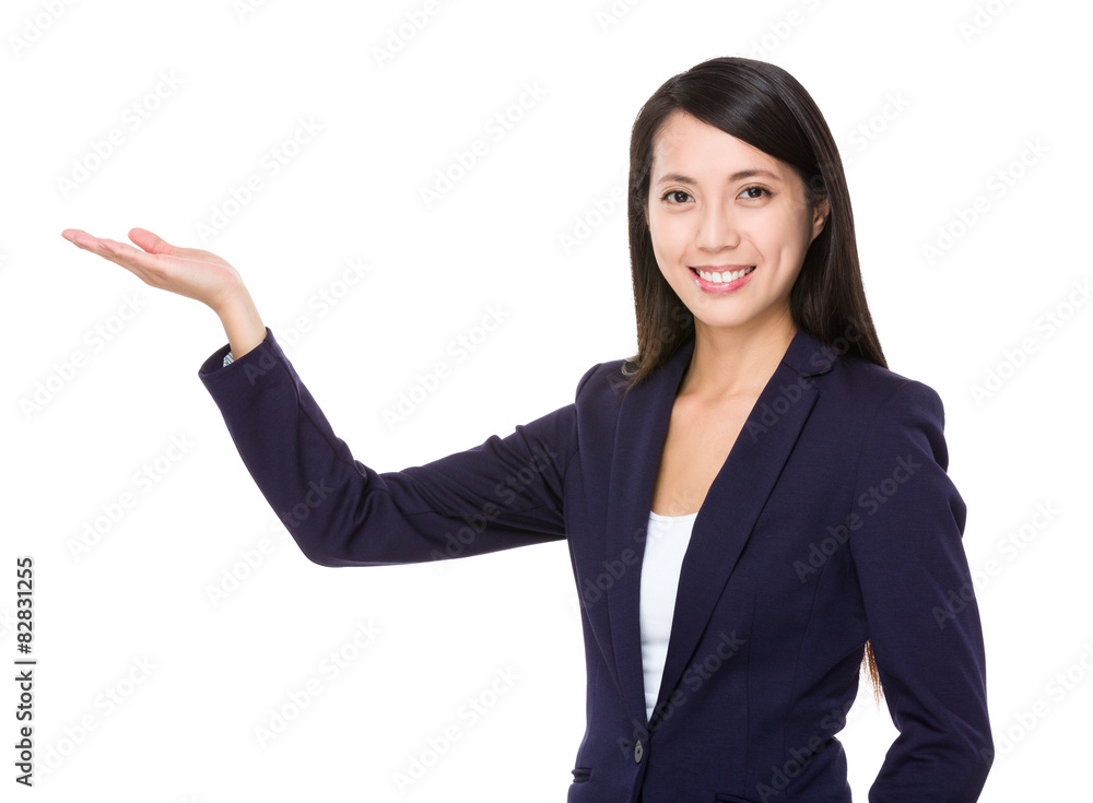Young businesswoman with hand showing blank space Young businesswoman with hand showing blank space