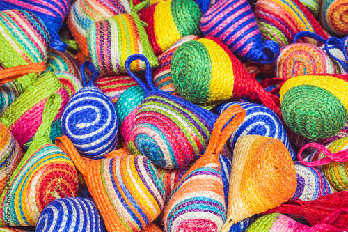 Close up stack of colorful handmade coin bag in market
