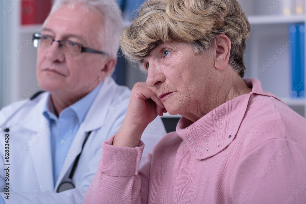 Sorrowful woman in doctor's office Sorrowful woman in doctor's office