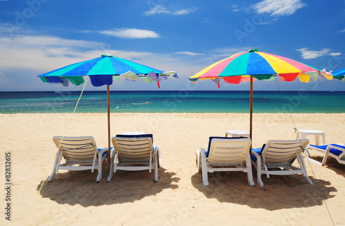 Summer paradise with white chair and colorful umbrella at Phuket beach, Thailand