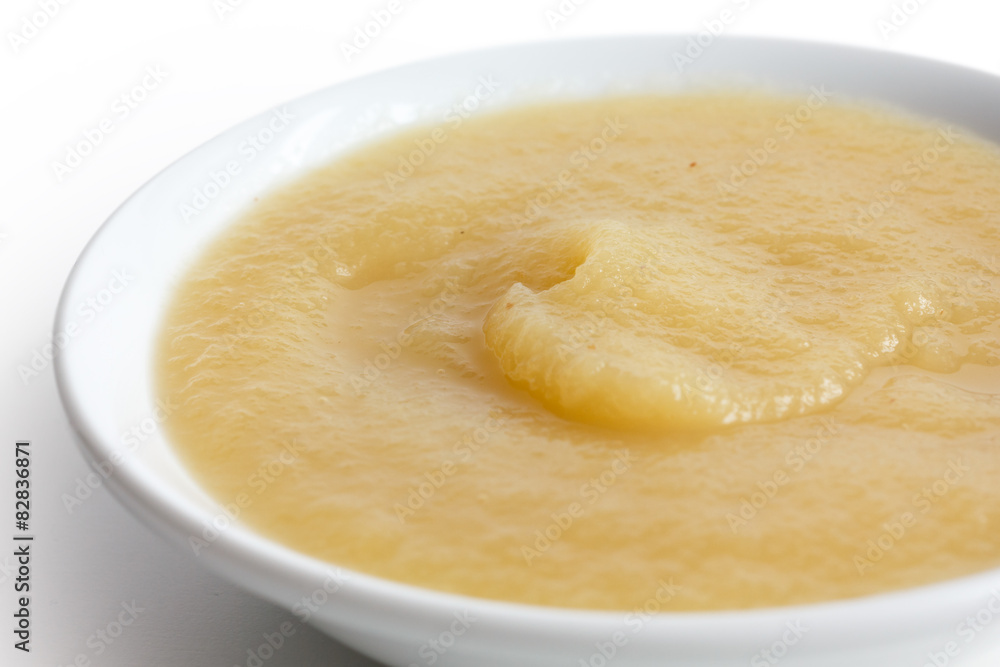 White ceramic dish of apple sauce on white. White ceramic dish of apple sauce on white.