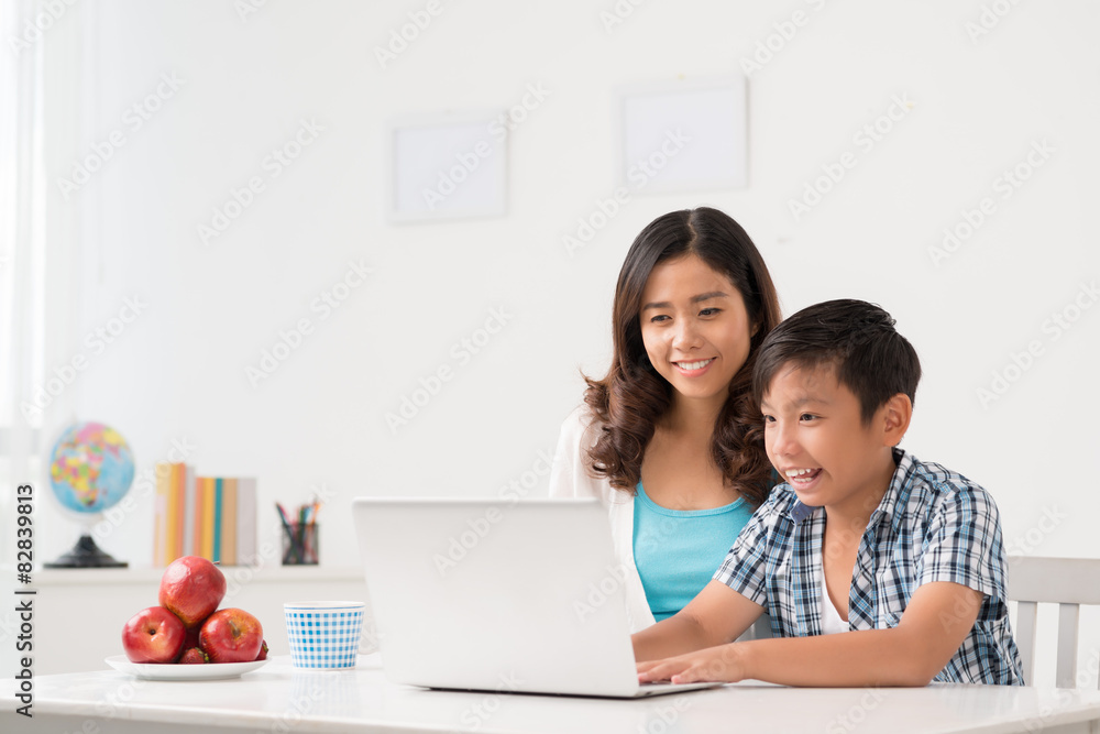 Mother and son at laptop