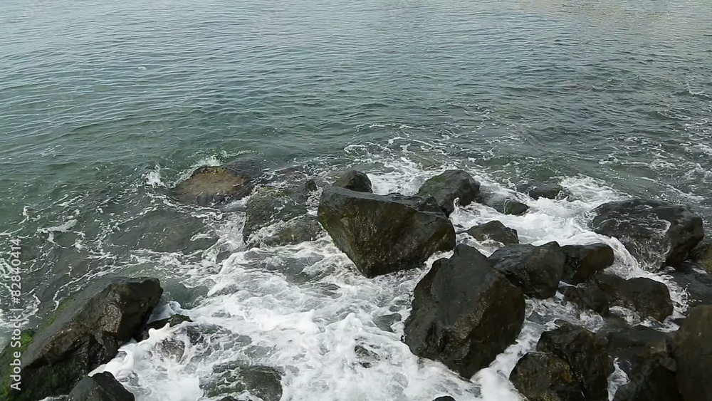 Water splashes in to beach rocks Water splashes in to beach rocks