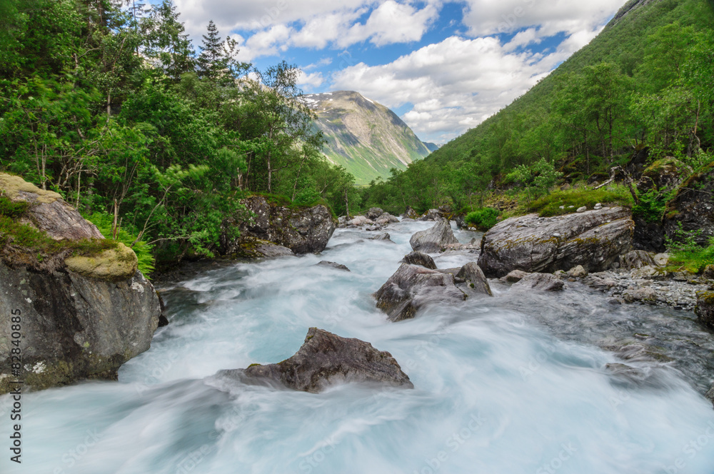 Flowing rapid stream at norwegian mountains Flowing rapid stream at norwegian mountains