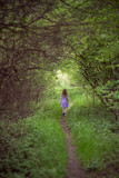 Little lonel girl in green nature gateway