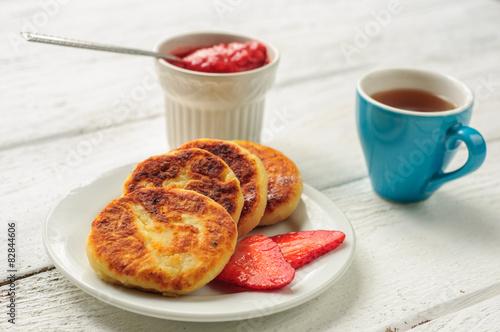 Breakfast with cottage cheese pancakes, strawberry jam and coffe