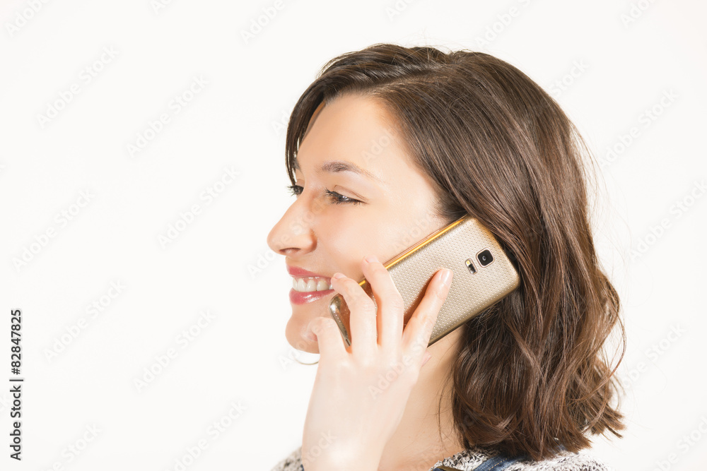 Young woman talking on the mobile phone smiling Young woman talking on the mobile phone smiling