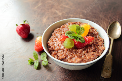 Bowl with sweet rice pudding with fresh fruits