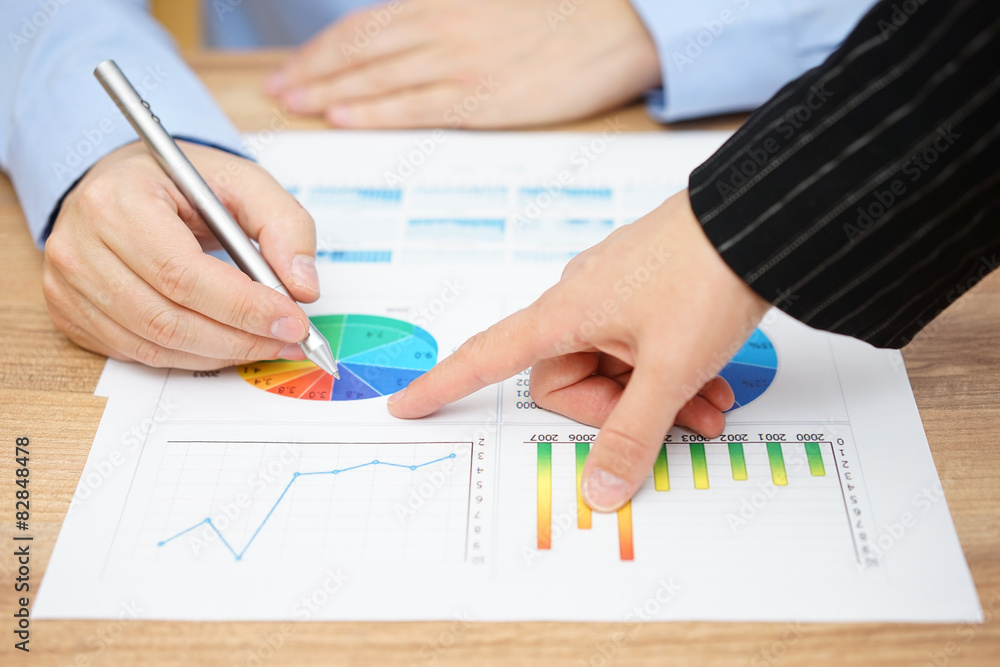 businesswoman showing sales report to his client businesswoman showing sales report to his client