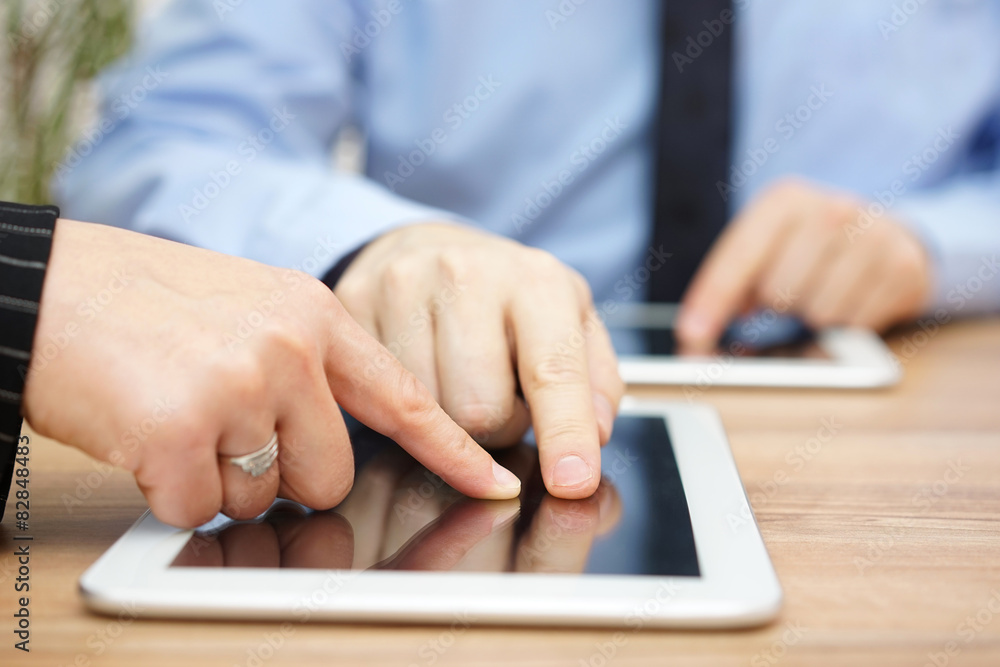 businessman is explaining report on tablet computer businessman is explaining report on tablet computer