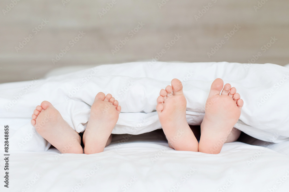 Children's legs peeking out from under a blanket Children's legs peeking out from under a blanket