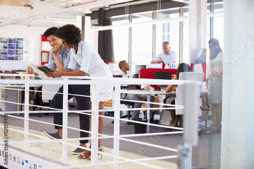 Staff working in a busy office mezzanine photo