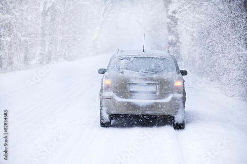 car on the winter road in snowstorm time © Nikolai Tsvetkov