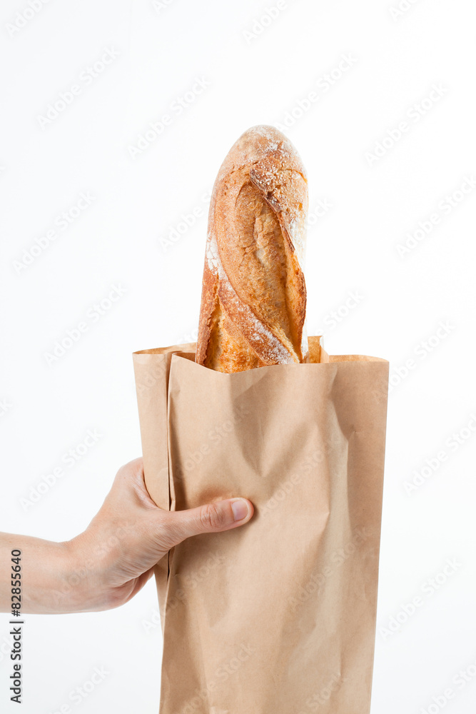 Hand holding a French baquette