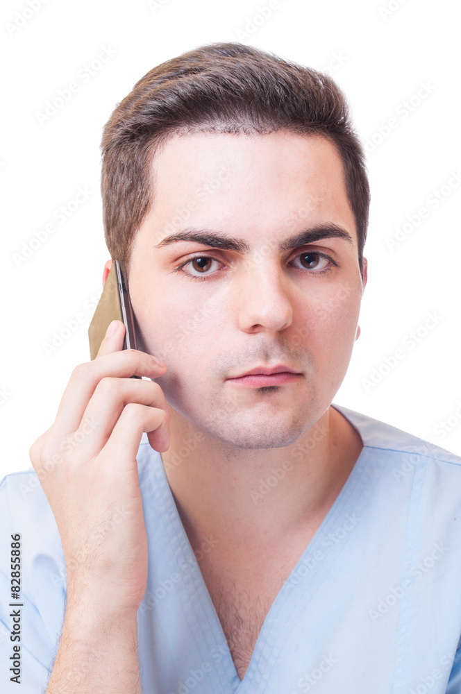 Male doctor talking on smartphone Male doctor talking on smartphone