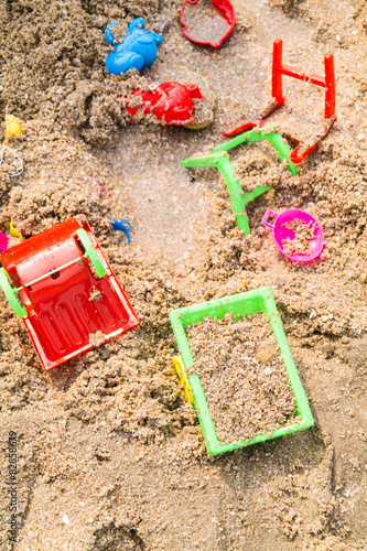 Children's toys on a sand beach