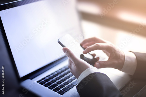 Businessman working on the laptop and smartphone