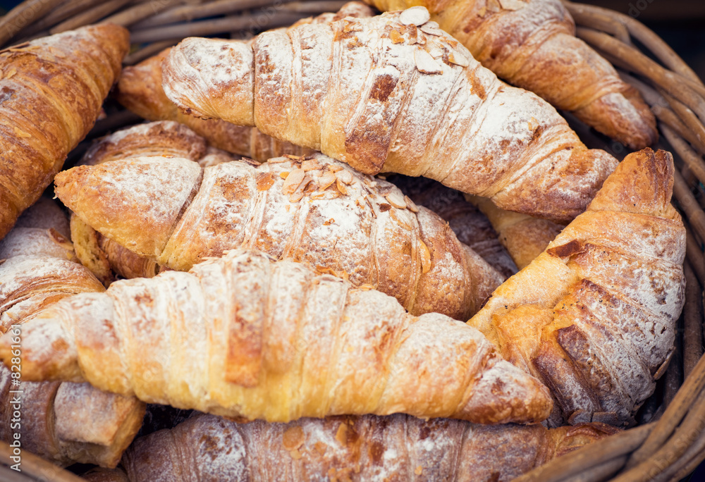 Homemade Almond Croissants in basket, food market display