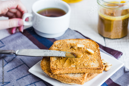 crispy toast with peanut butter, bananas, coffee, breakfast © harmoony