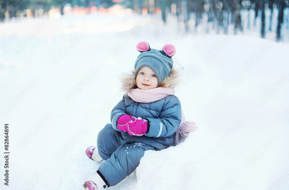 Child playing on the snow in winter day Child playing on the snow in winter day