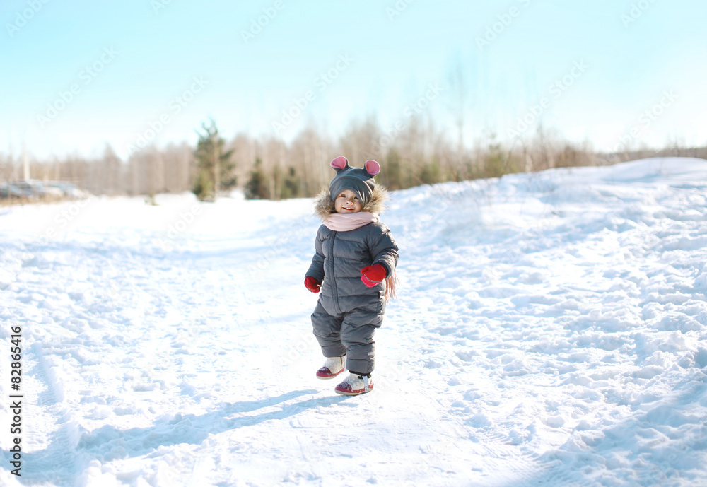 Happy child walking in sunny winter day